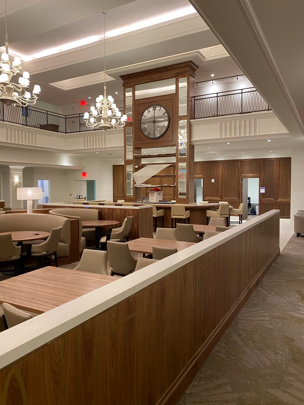 Dining hall featuring wood-toned panelling, built-in booth seating, and a central clock millwork tower