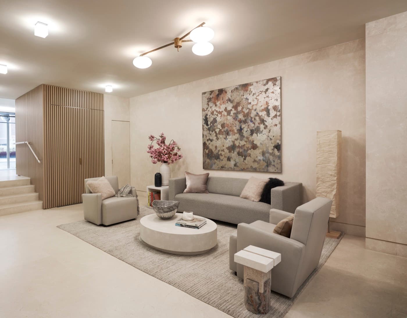 Modern lobby seating area with vertical slatted timber panelling and pale stone wall cladding
