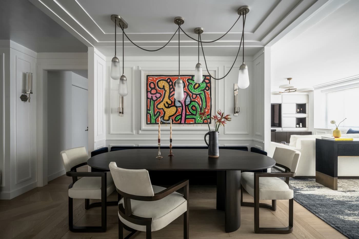 Dining area with painted wall panelling, stepped ceiling moulding, and draped pendant lighting