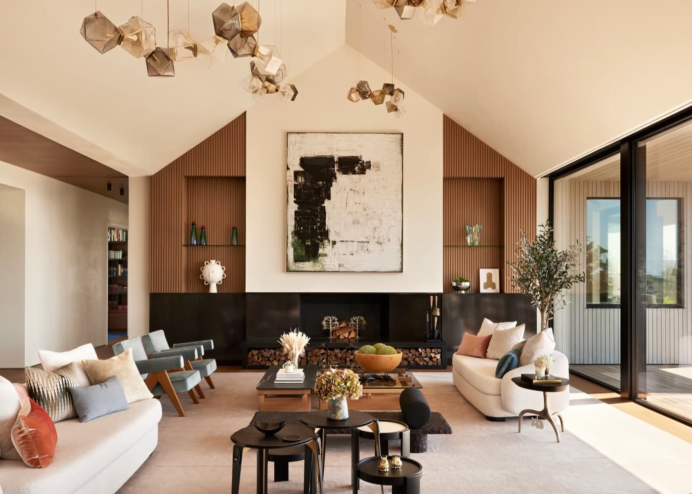 Vaulted living room with a dark hearth flanked by fluted timber wall panelling