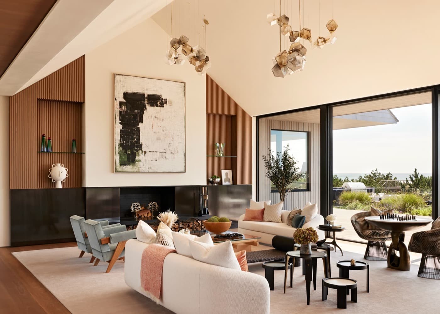 Living room with fluted timber wall panelling flanking a fireplace and dark metal built-ins