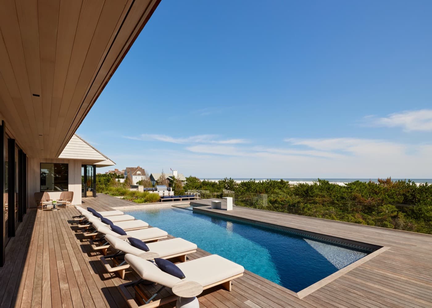 Outdoor pool deck featuring timber decking, swimming pool, and an expansive timber overhang