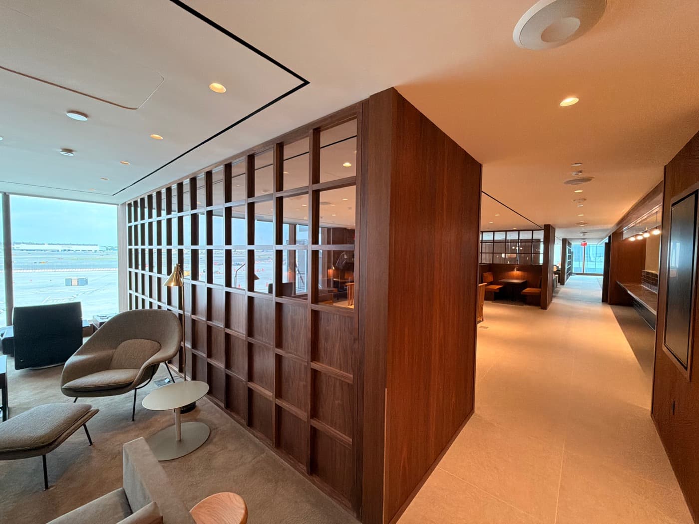 Airport lounge featuring dark timber grid partition screens and matching wall panelling