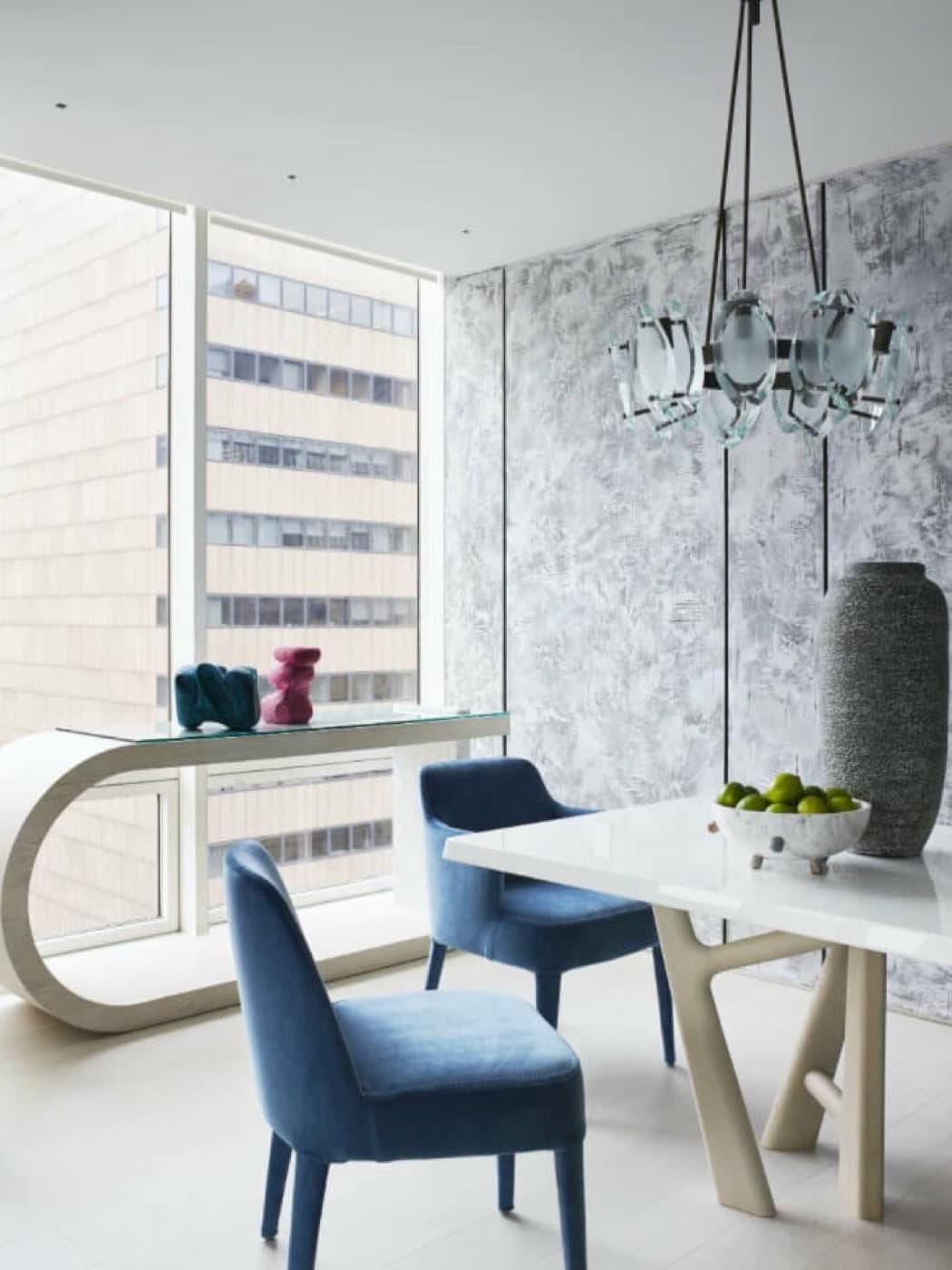 Dining room featuring textured wall panelling, contemporary light fixture, and floor-to-ceiling windows