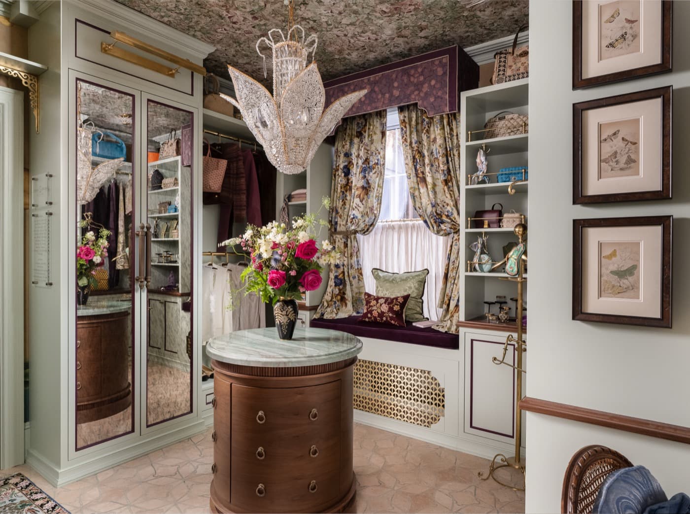Dressing room featuring custom built-in cabinetry, mirrored wardrobe doors, window seat, and curved timber island