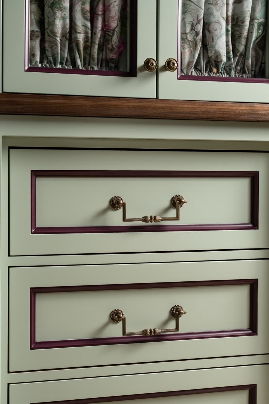 Dressing room custom painted cabinetry drawers with contrasting moulding and decorative metal hardware