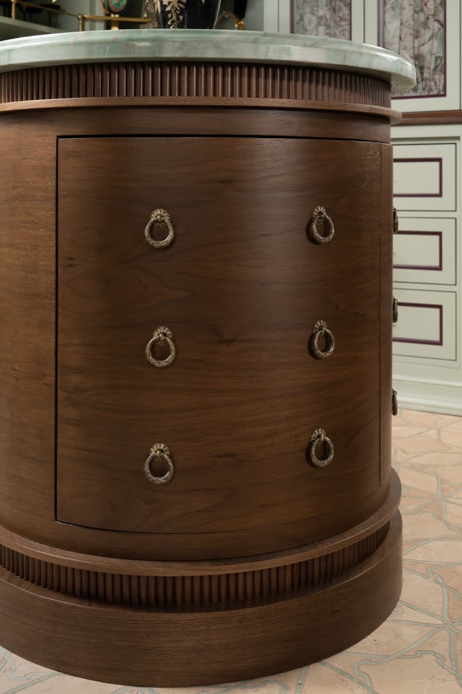 Dressing room with custom curved dark timber cabinetry, fluted trim, and green stone countertop