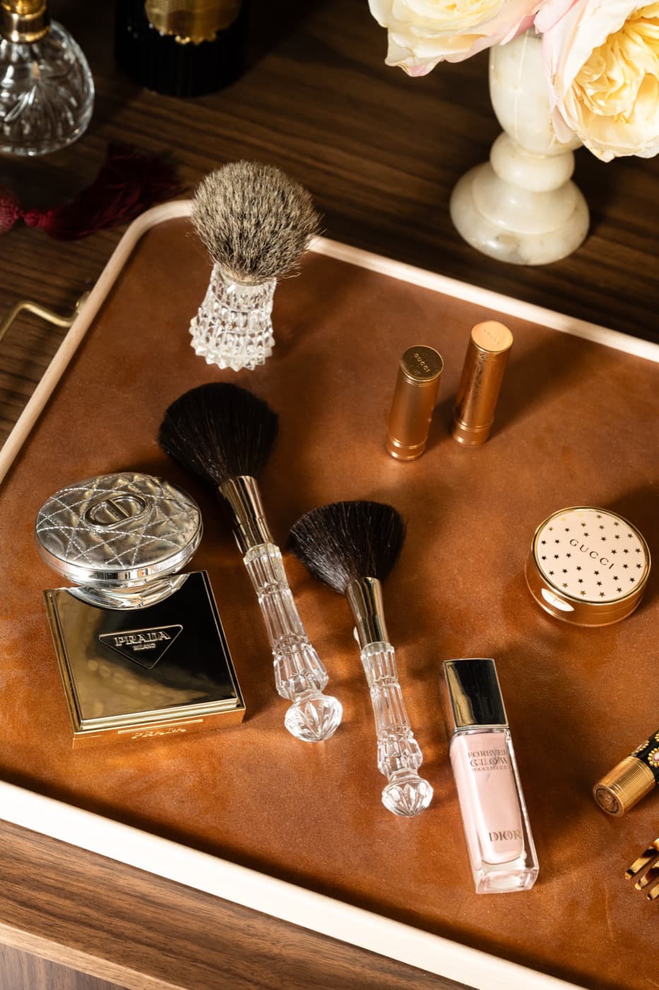 Dressing room detail featuring a leather-lined tray placed on a dark timber tabletop