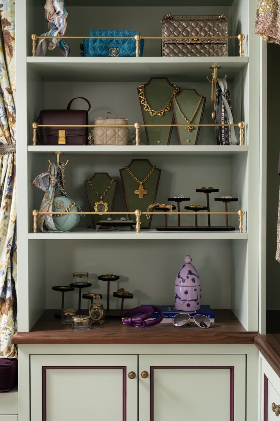 Dressing room custom painted shelving unit with brass gallery rails and lower cabinetry