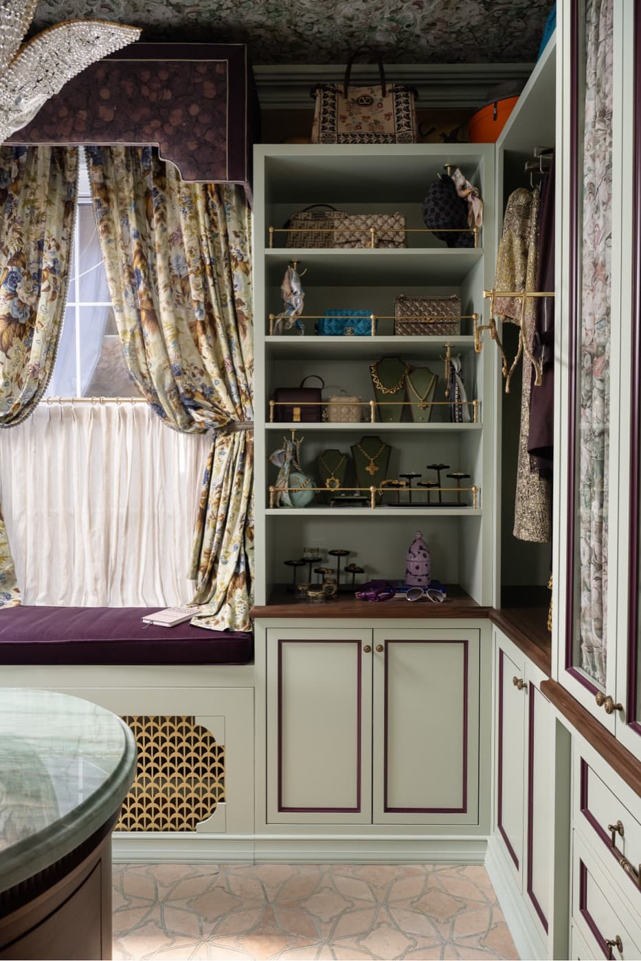 Dressing room featuring custom painted millwork, brass gallery shelves, and an upholstered window seat