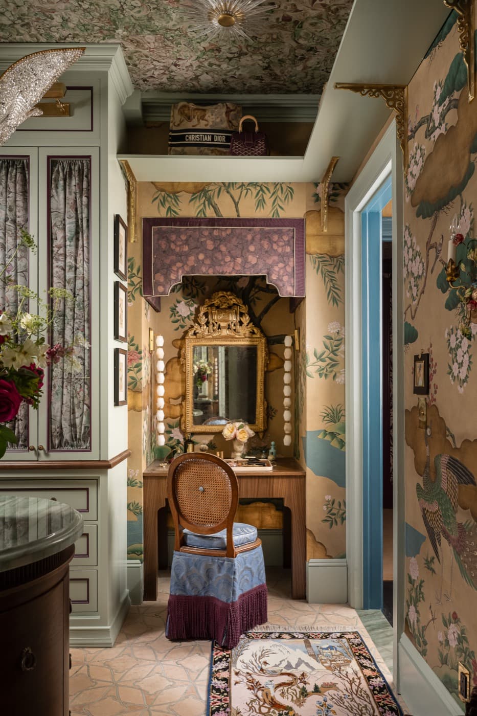 Dressing room featuring painted built-in cabinetry and a timber vanity in a wallpapered alcove