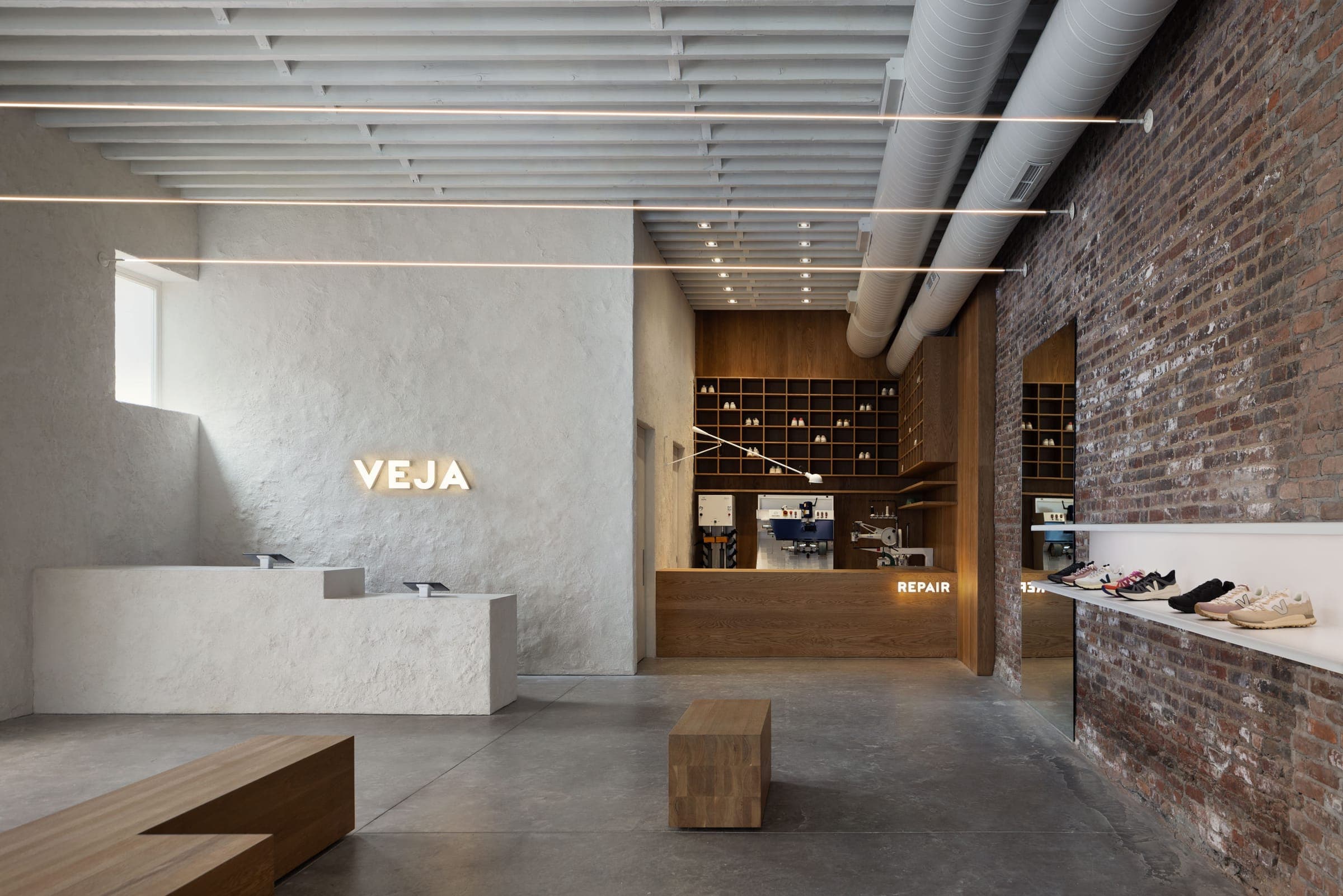 Retail store interior with textured plaster counter and custom timber repair desk with shelving