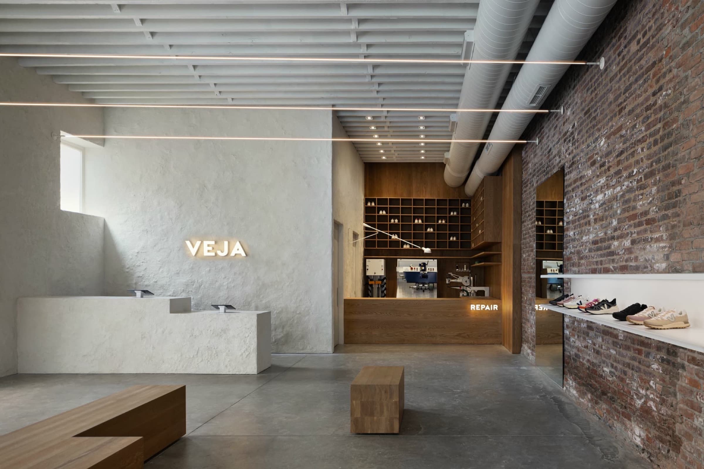 Retail store interior with textured plaster counter and custom timber repair desk with shelving